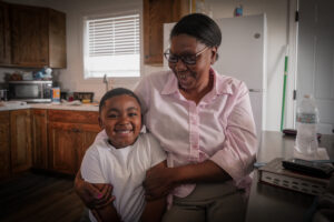 Betty and her Grandson smiling in their new home