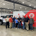 Salvation Army representatives pose in front of a new Embassy Specialty Canteen