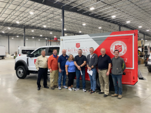 Salvation Army representatives pose in front of a new Embassy Specialty Canteen