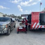 car in line to receive relief supplies