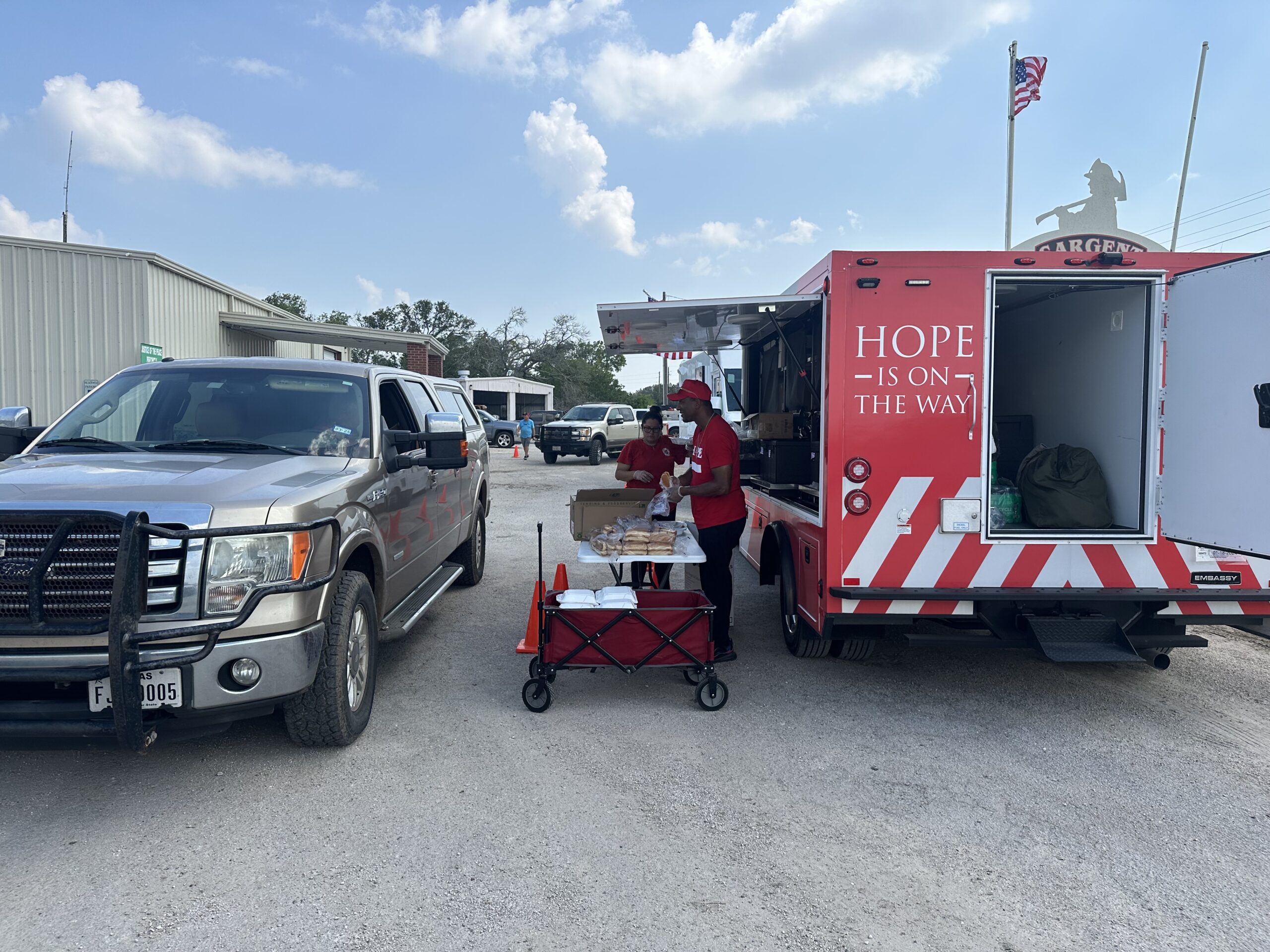 car in line to receive relief supplies