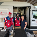 Volunteers pose in front of canteen